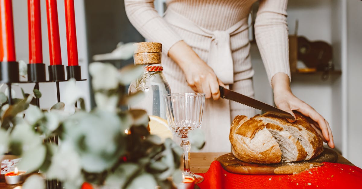 Care and warping of wooden chopping board - A Woman Slicing a Loaf of Bread on a Chopping Board