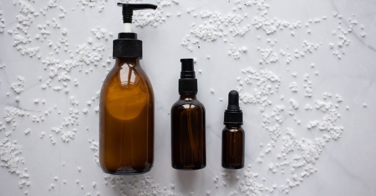 Cast iron moisture on inside top - Bottles of cosmetic products placed on white surface