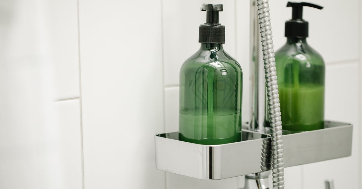 Caulk gun-like dispenser for whipped cream - Green dispensers on shelf on shower system