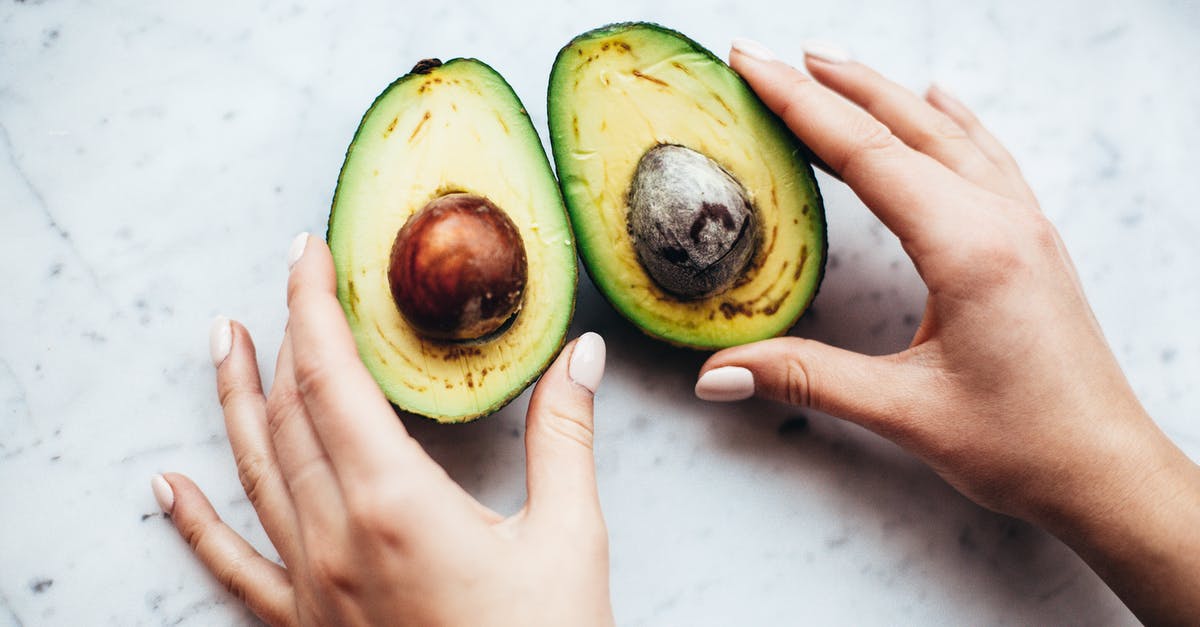 Celeriac (aka: Celery Root) Skin - Edible or Not? - Person Holding Sliced Avocado