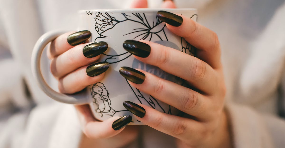 Ceramic Coffee mug measurement - Woman With Black Manicure Holding White and Grey Floral Ceramic Cup