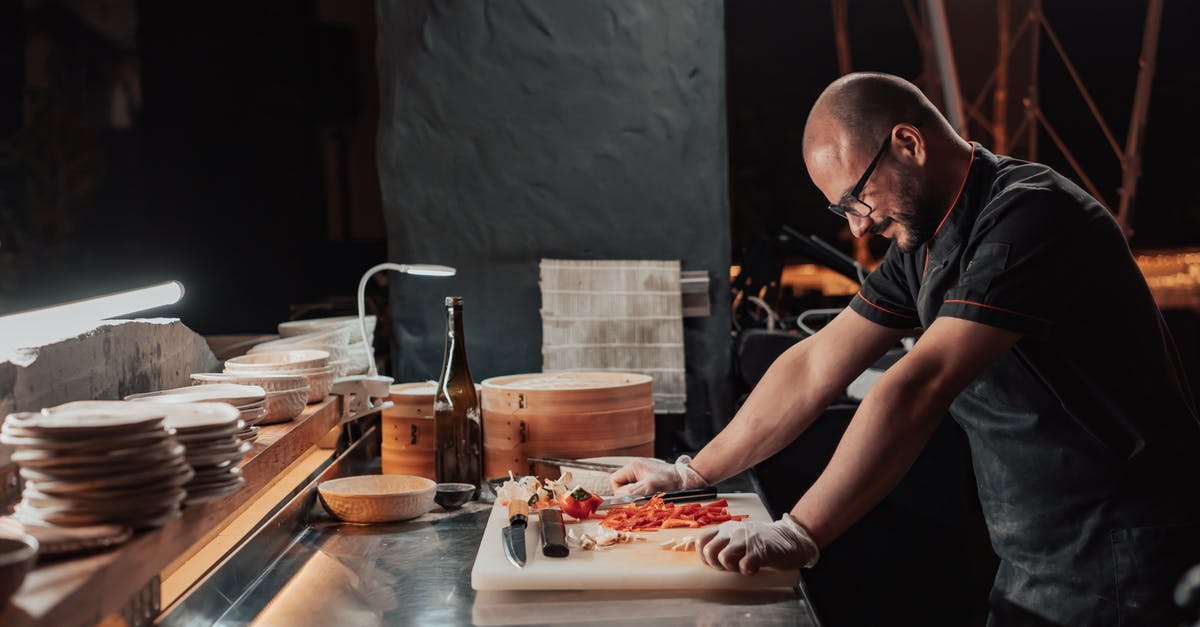 Ceramic knives for boning? - Man in Black Chef Uniform Standing by the Chopping Board