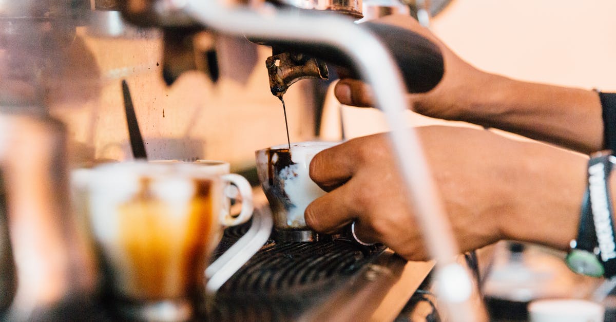 Ceramic vs Stainless Steel in coffee mugs - Faceless employee pouring coffee from machine in cafeteria