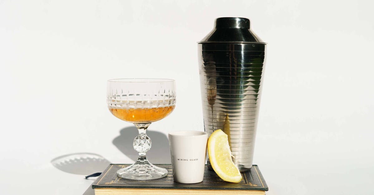 Ceramic vs Stainless Steel in coffee mugs - Glass of cognac with coffee and shaker on book