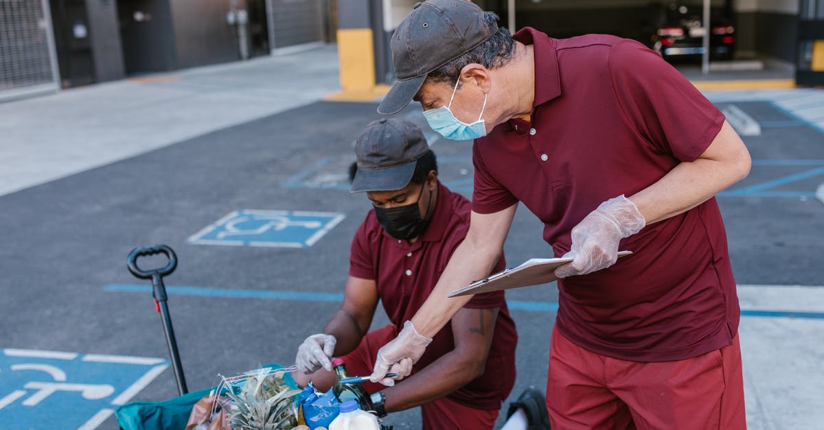 Checking food nutrients - Man in Red Polo Shirt Holding Brown Wooden Stick