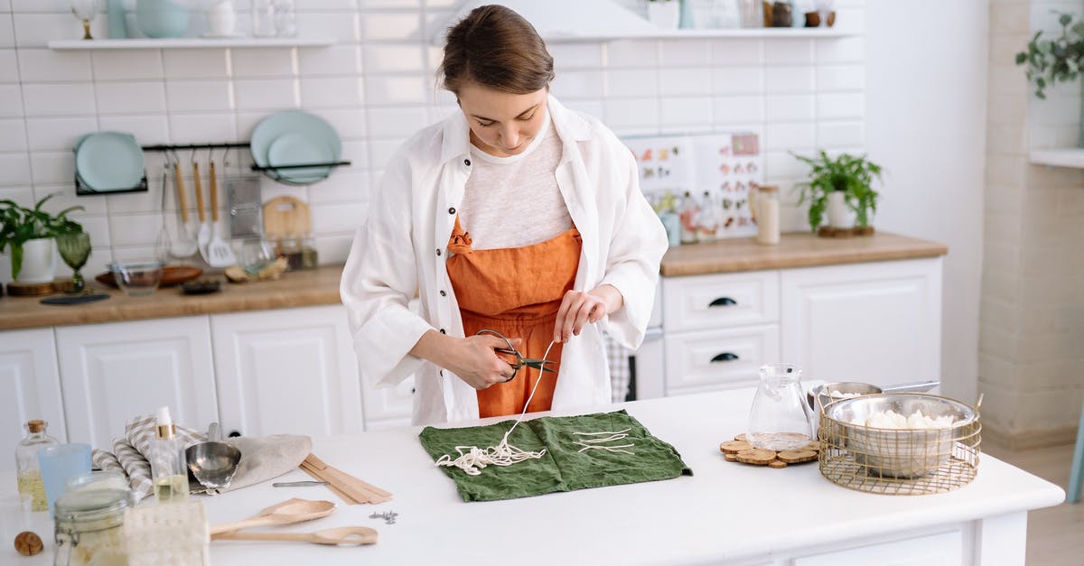 Cheese Cutting Tools - A Woman Cutting Candle Wicks with Scissors