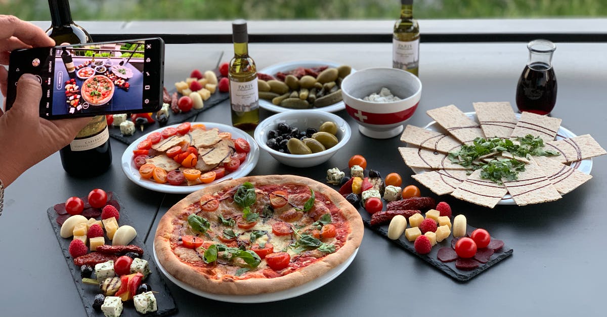 Cheese Extract - How to Use it? - Unrecognizable person photographing table with pizza and assorted snacks