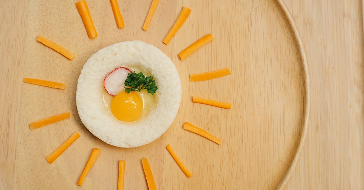 Cheese soufflé with bread cubes instead of egg whites - Appetizing raw egg toast decorated with cheese sticks