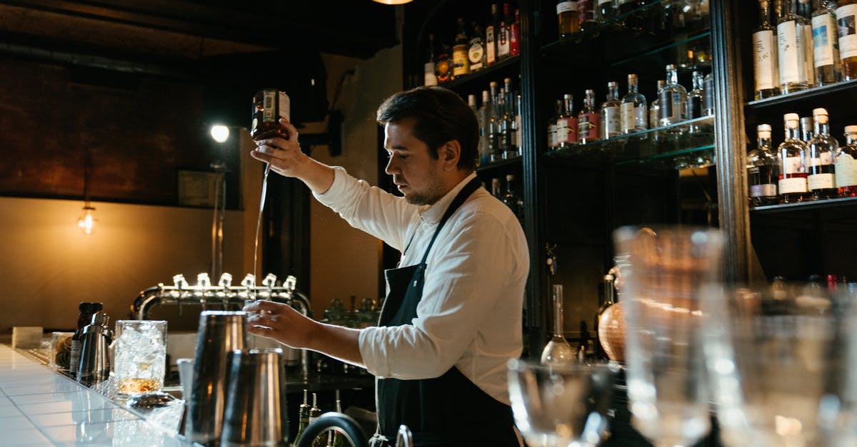 Chemical process behind hardening ice cream - Man in White Long Sleeve Shirt Pouring Wine on Clear Wine Glass