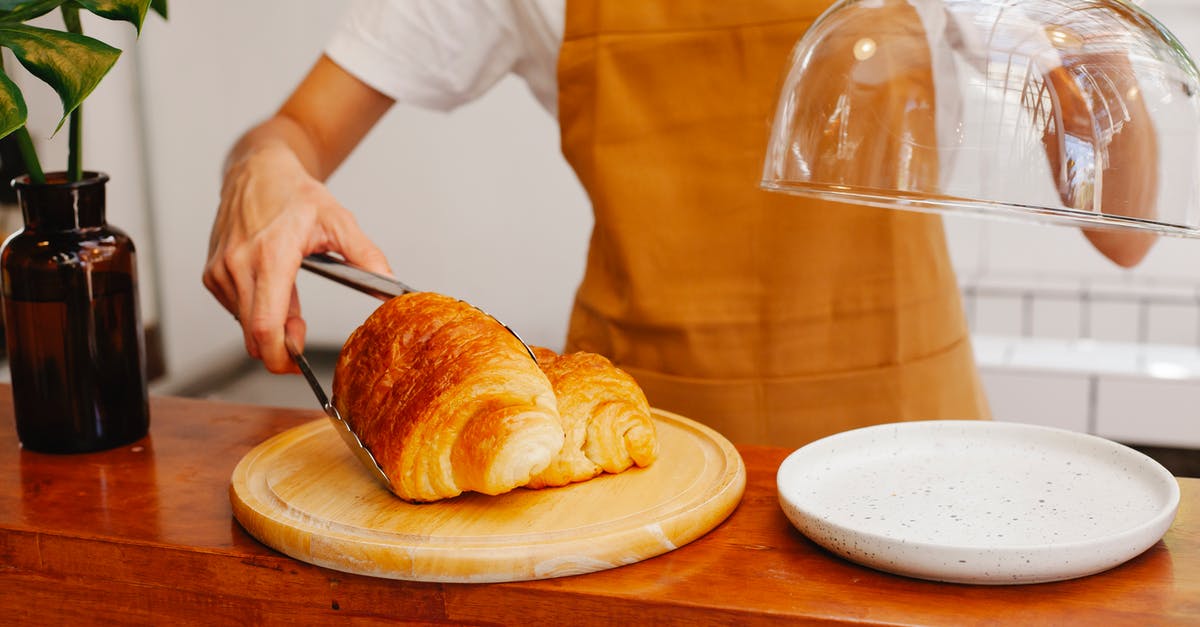 Chilled puff pastry vs frozen - Crop anonymous female employee in apron putting tasty pastries with tongs on plate in bakery