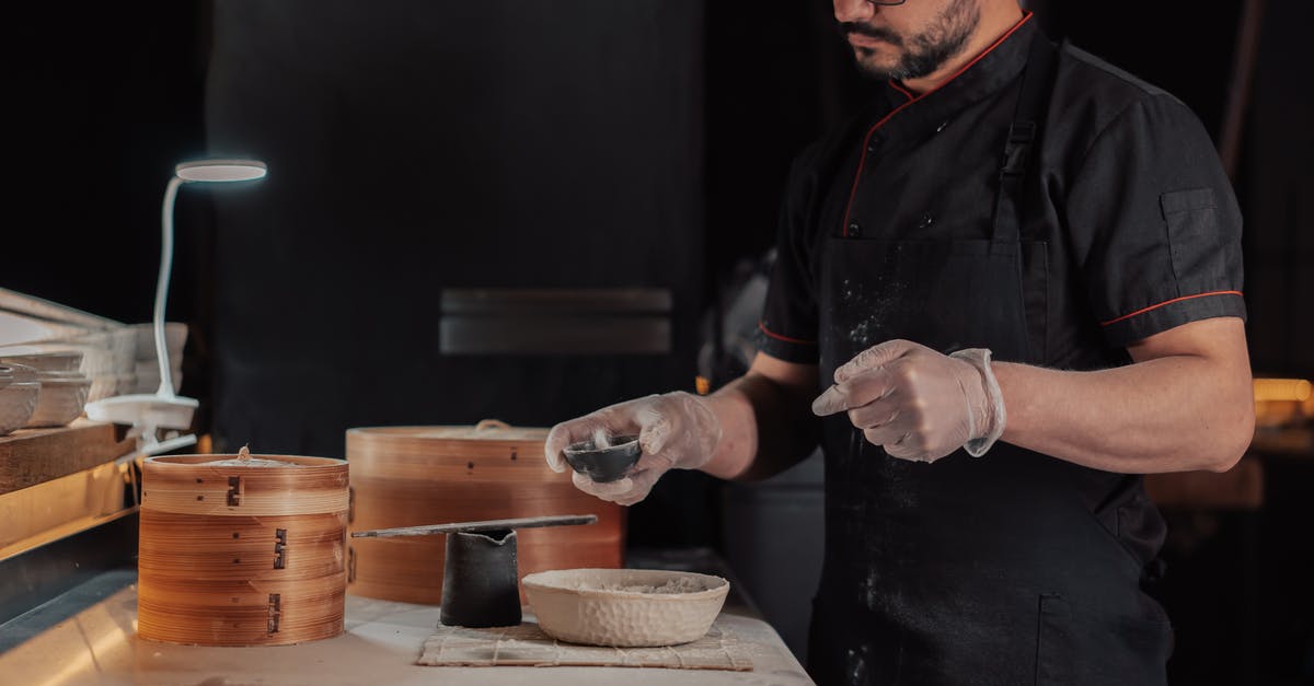 Chinese cooking wine varieties - Person in Black Apron Holding Brown Clay Pot