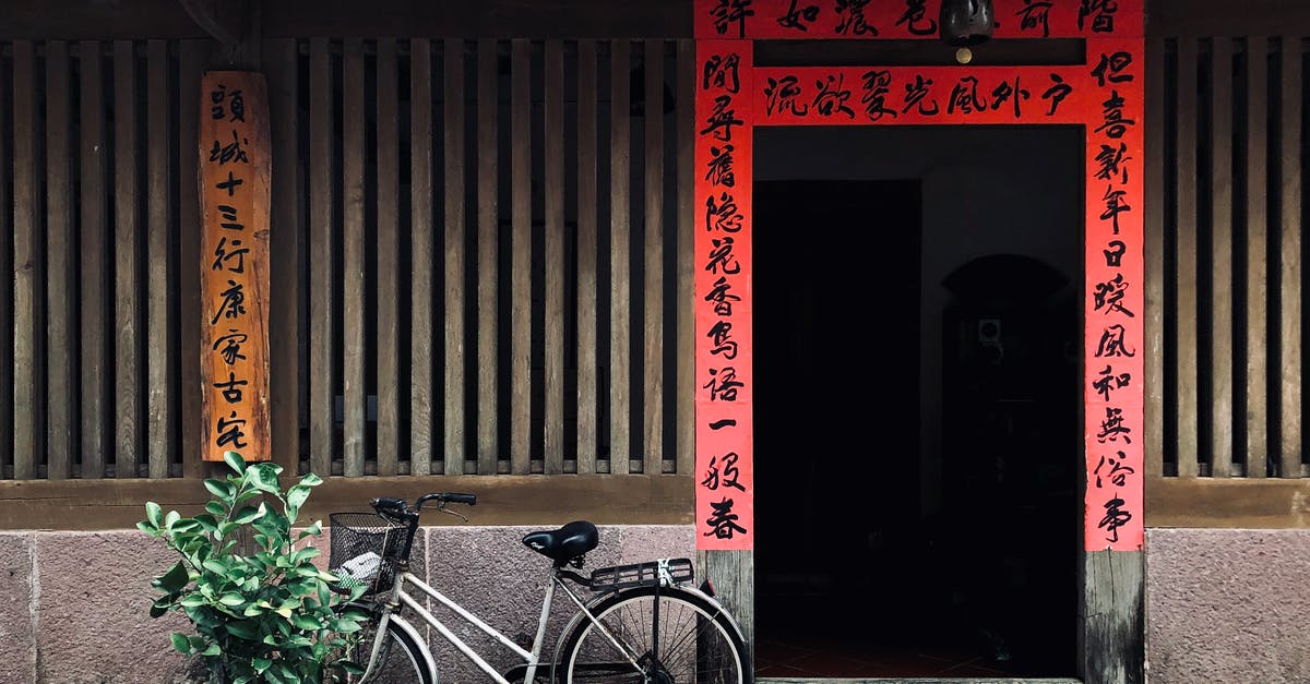 Chinese Hoppin' John - Black City Bike Parked Beside Red Wooden Door