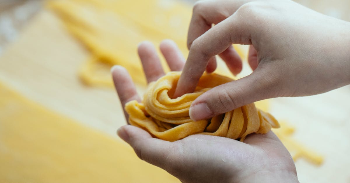 Chinese noodle dough breaking when pulled - Woman making homemade pasta with egg dough