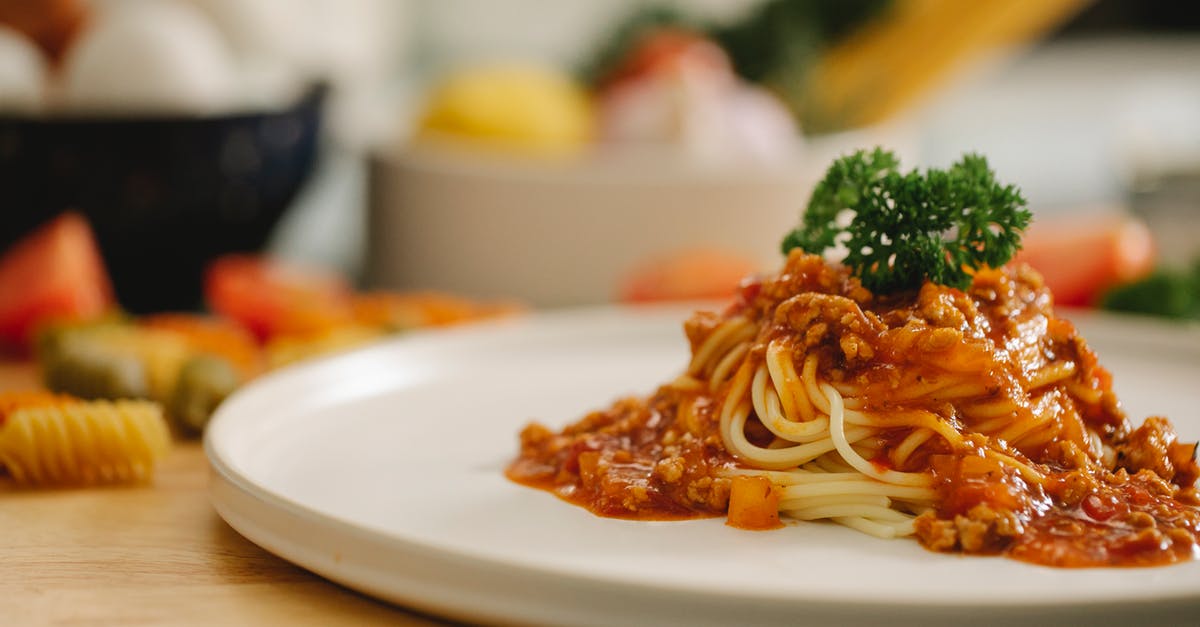 Choc pudding, cook & serve hasn't thickened - Delicious yummy spaghetti pasta with Bolognese sauce garnished with parsley and served on table in light kitchen