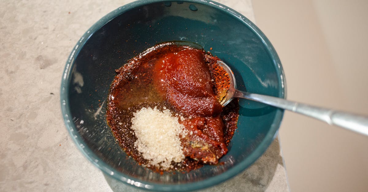 Chocolate and oil mixed - Mixed Powder Ingredients in a Bowl With Silver Spoon