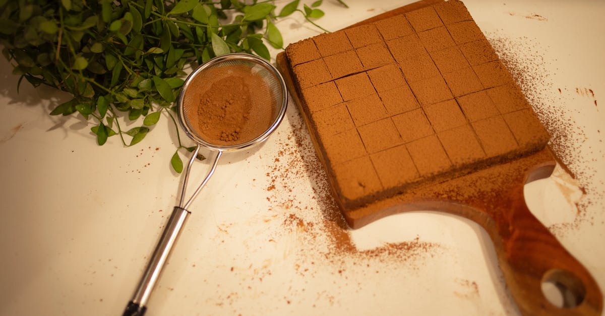 chocolate substitutions in baking brownies from scratch - Chocolate Brownie on Wooden Board and Sieve with Cocoa Powder