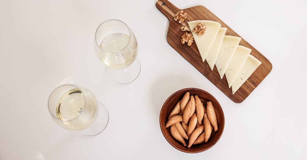 Chop nuts before or after toasting? - Overhead Shot of Glasses of Wine and Cheese Slices