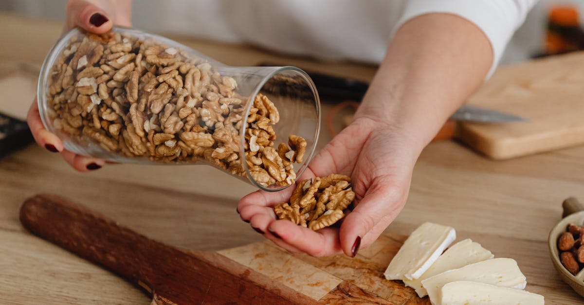 Chop nuts before or after toasting? - Person Holding Brown Wooden Chopping Board With Brown Dried Leaves