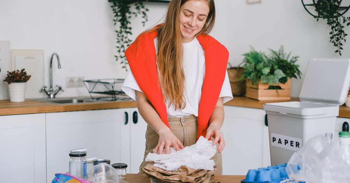 Chopped onions in metal or plastic containers - Smiling woman stacking paper litter for reuse