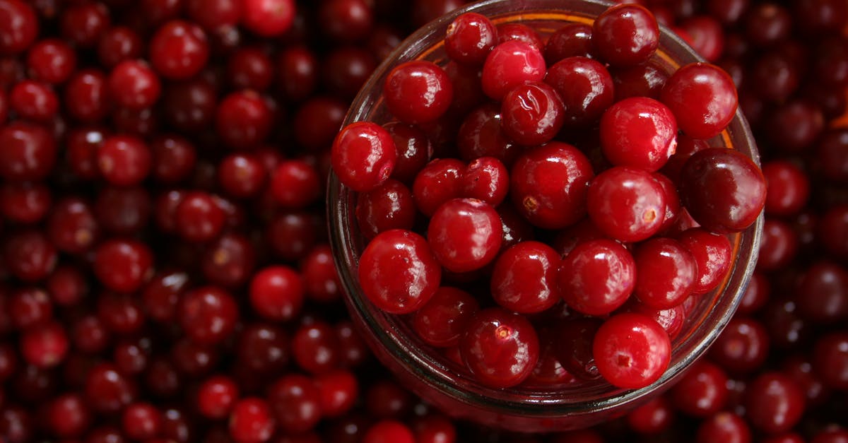 Chopping fresh cranberries - Close-up of Strawberries