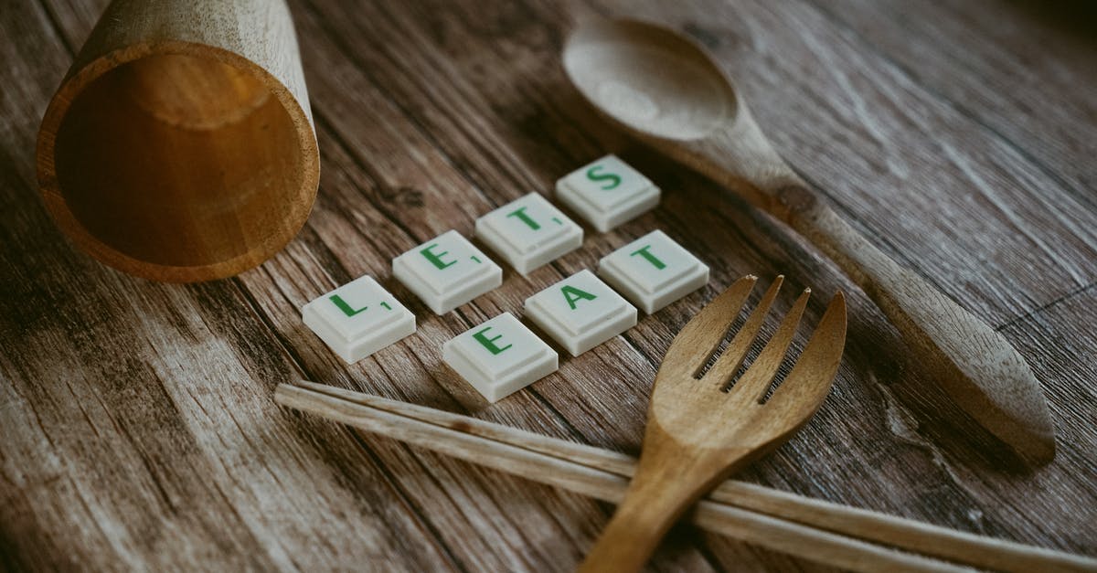 Chopsticks versus forks? - Wooden Fork and Spoon with Cup Near Chopsticks