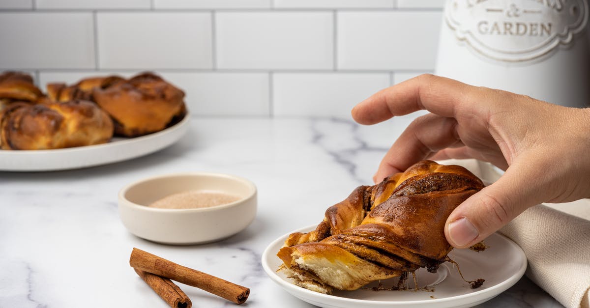 cinnamon in bread dough - A Person Eating a Cinnamon Bread