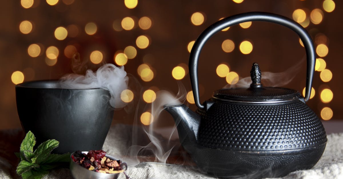 Cleaning a tea pot - Close-up of Black Teapot