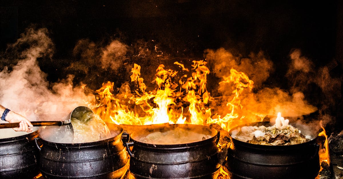 Cleaning burnt beans stuck to pot? - Time Lapse Photography of Four Black Metal Cooking Wares