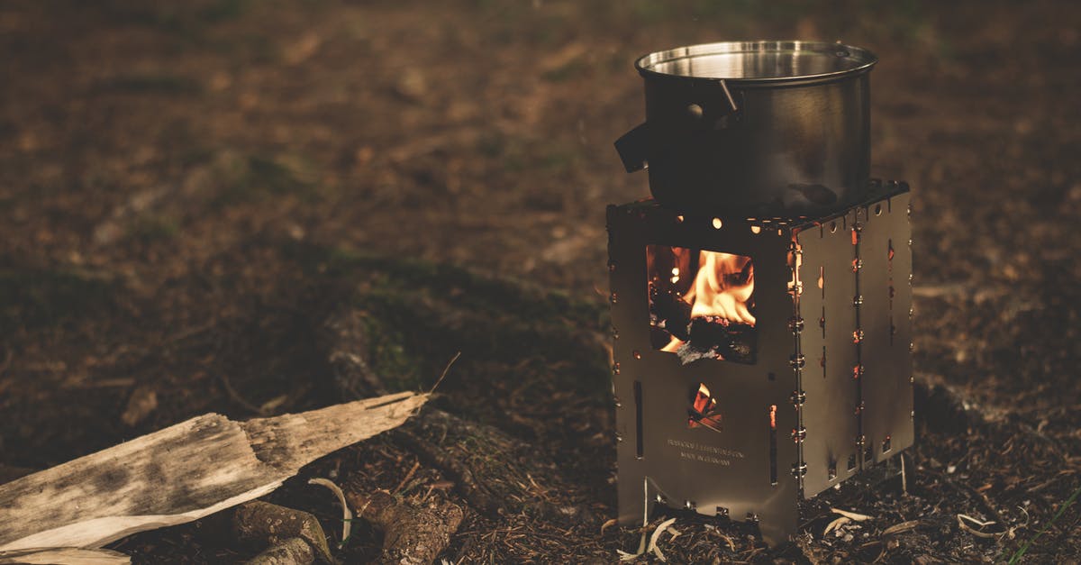 Cleaning burnt beans stuck to pot? - Stainless Steel Pot on Brown Wood Stove Outside during Night Time