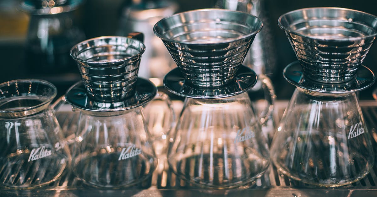 Cleaning out coffee pots and thermoses - Set of similar crystal glass coffee pots with funnels for filters in coffee shop