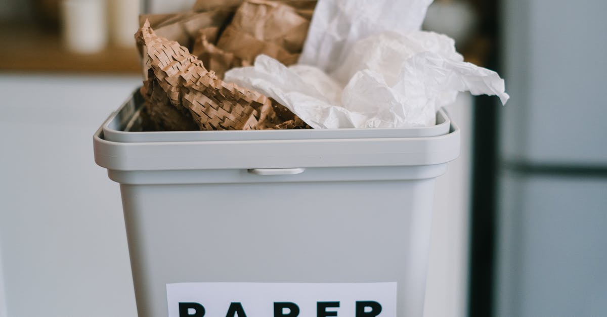 Cleaning plastic bags used for sous vide - Closeup of plastic container full of paper placed on blurred background of kitchen in daytime