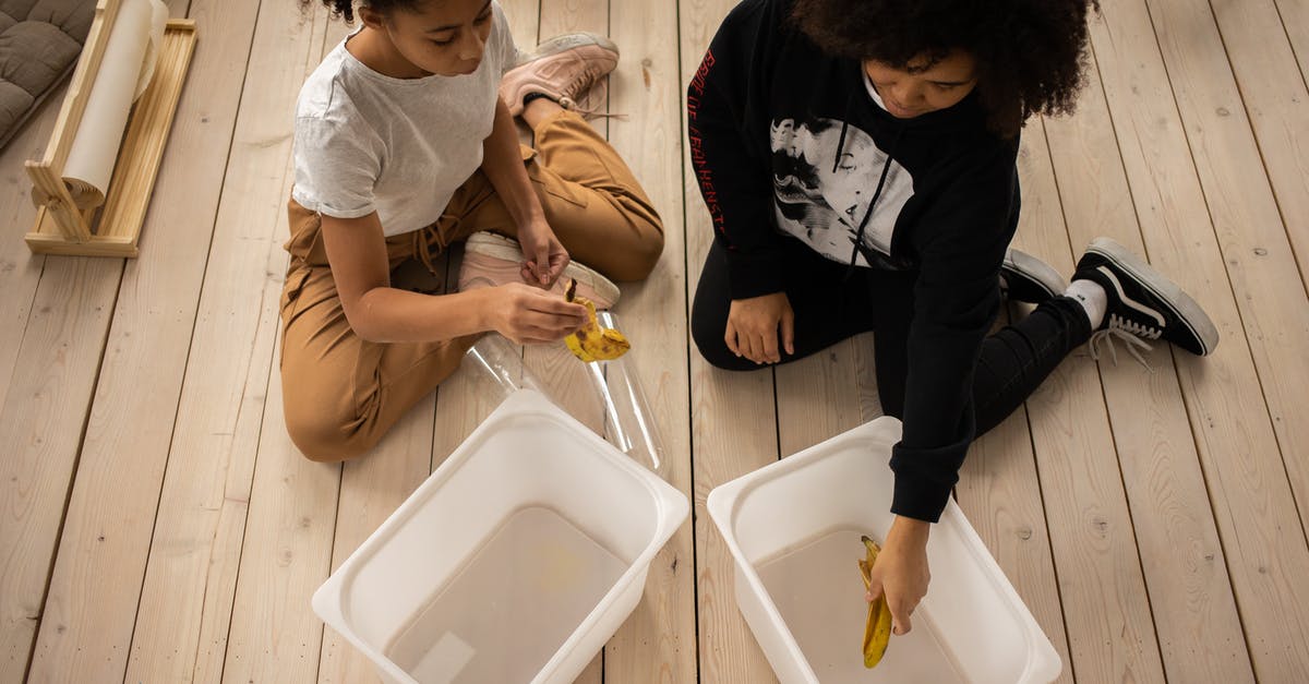 Cleaning plastic bags used for sous vide - Black mother and daughter sorting garbage into containers