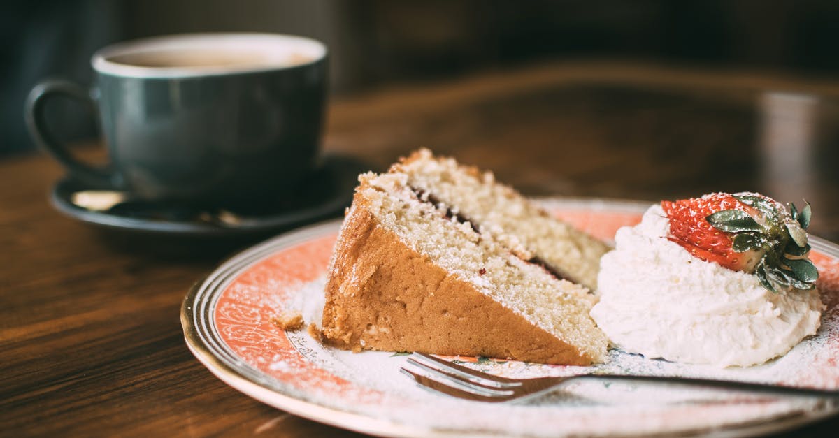 Coating fruit before adding to a cake - Photo of Sliced Cake on Ceramic Plate