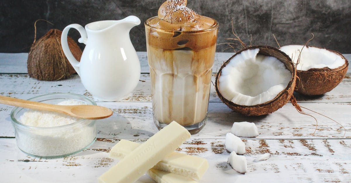 Coconut milk in iced coffee - White Ceramic Pitcher Beside Clear Glass Bowl on Brown Wooden Table