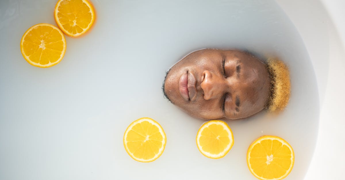 Coconut milk looks like water with butter chunks - Black man immersed in bathtub