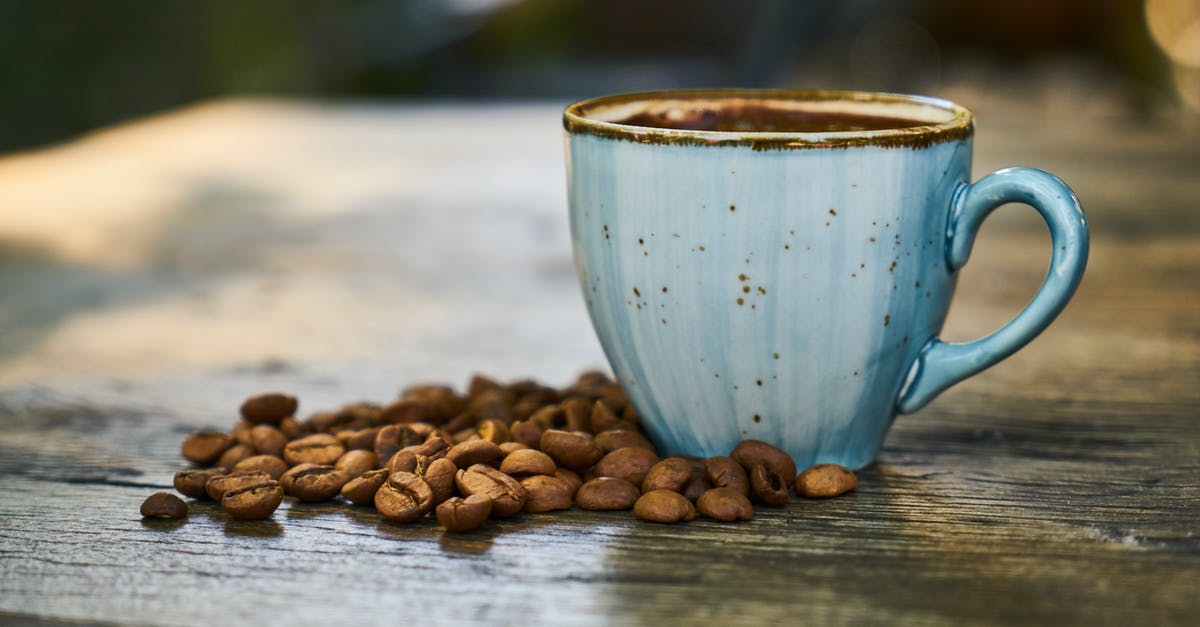 coffee from seeds of dates - Blue Cup Near Coffee Beans