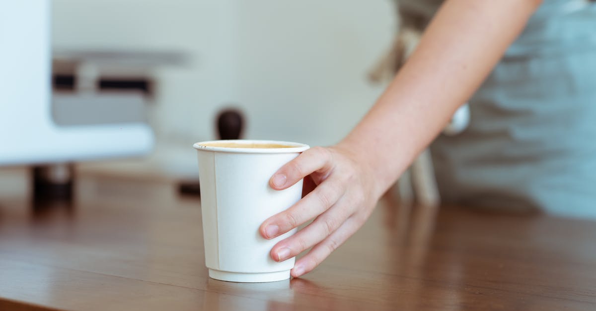 Coffee in a rattlesnake recipe? Why? - Crop barista serving coffee in paper cup