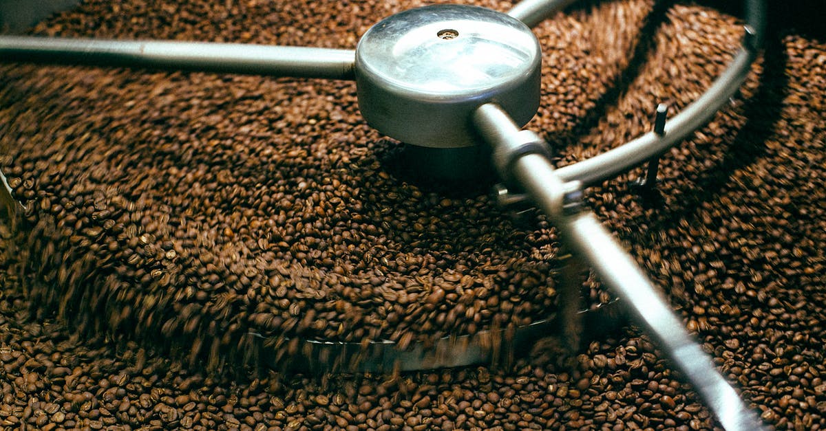 Coffee roasting, worth upgrade from popcorn popper - From above of fresh aromatic brown coffee beans mixing in professional roasting machine