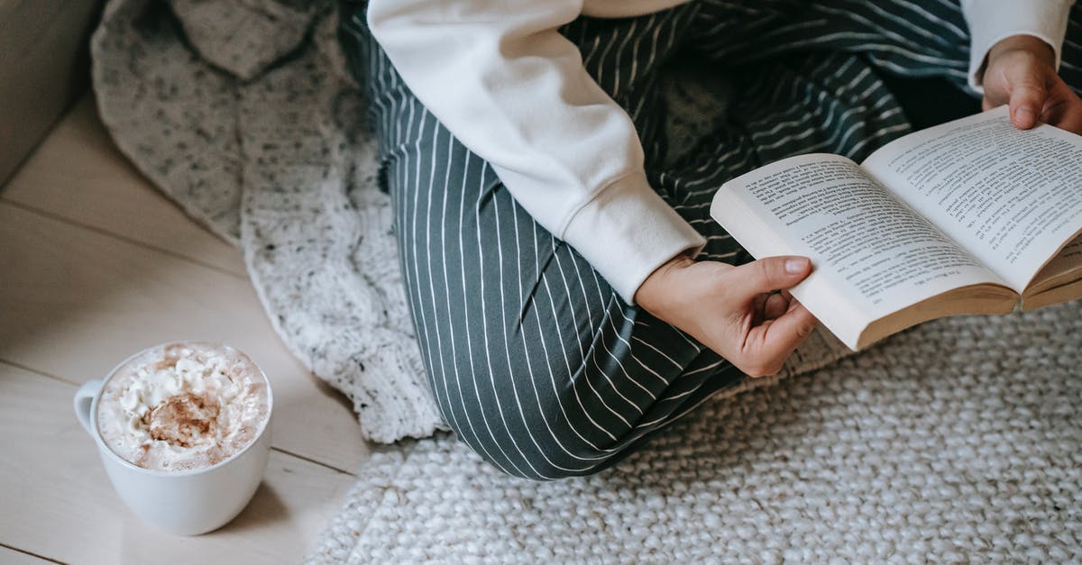 Coffee whipped cream filling - Female reading book while drinking coffee with whipped cream