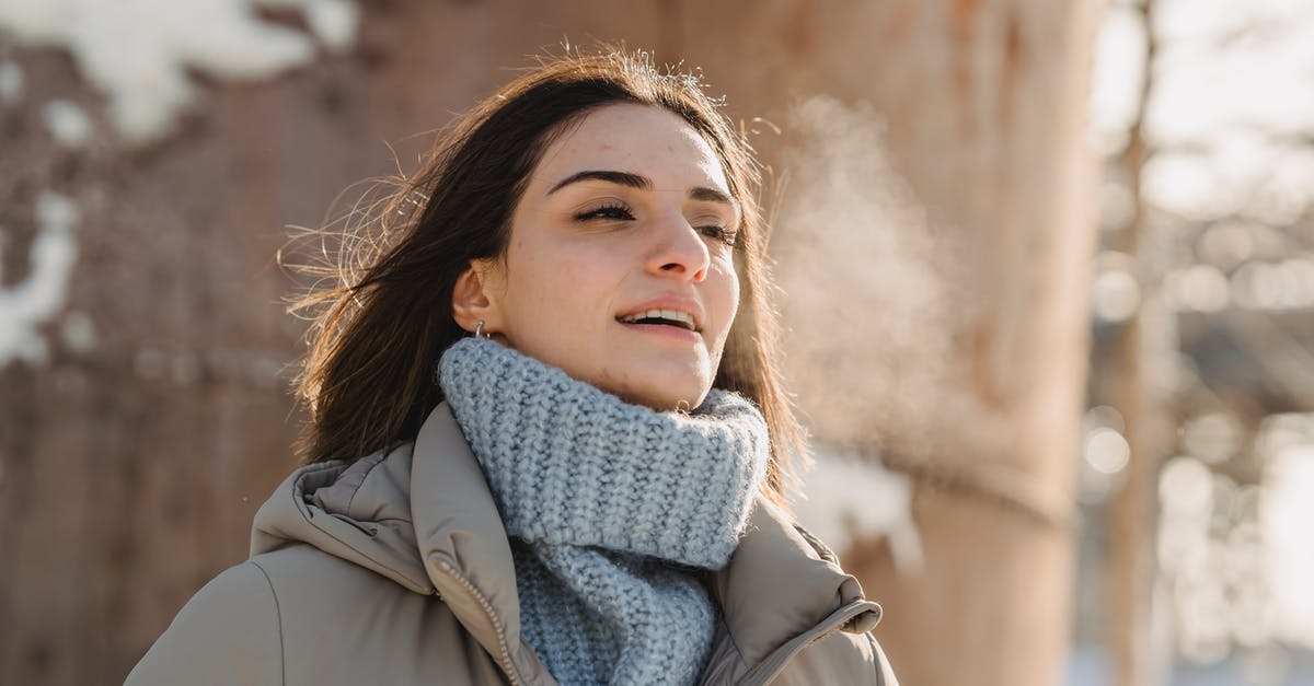 Cold Smoking in the Tropics - Condensation - Young woman exhaling steam on freezing cold weather