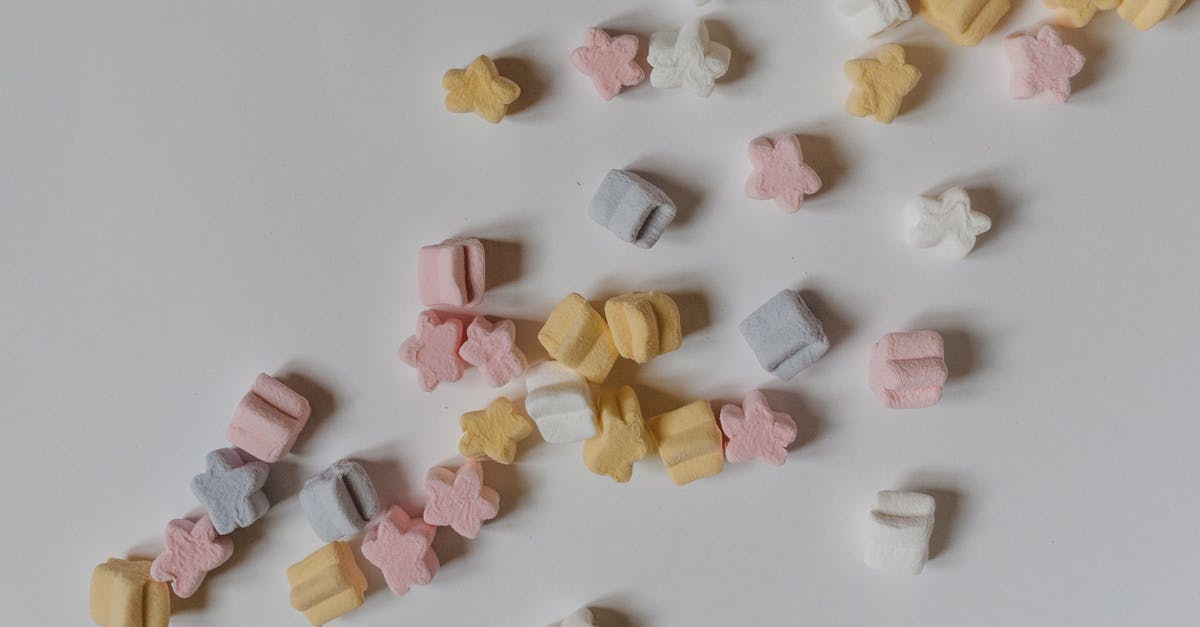Colorful Marshmallow - Top view composition of sweet yummy marshmallows in shape of stars scattered on white surface