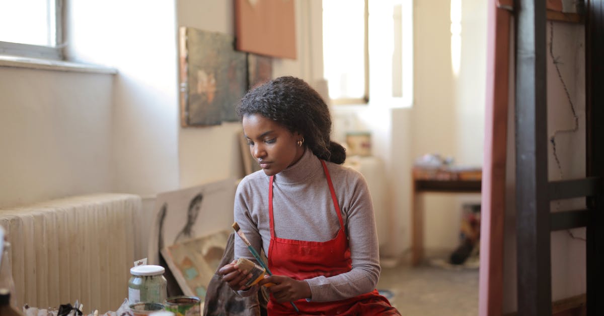 Colouring oil - chocolate look alike - Young woman working in creative workshop