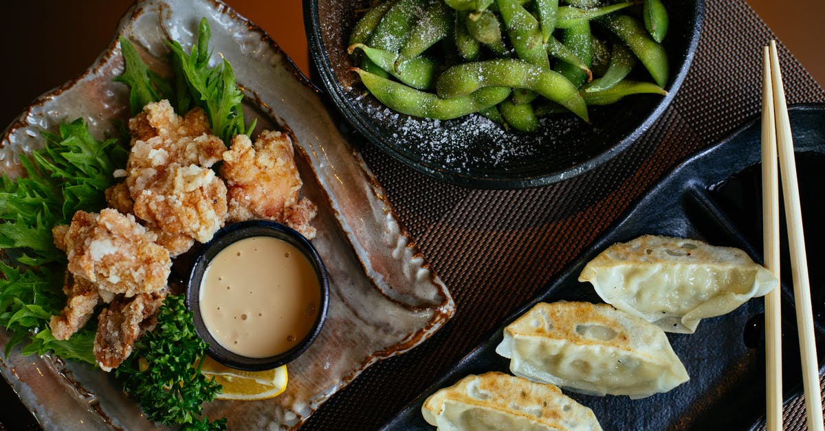 Combining chicken and vegetables in sous vide - Dumplings on Black Plate Beside Green Beans and Fried Food