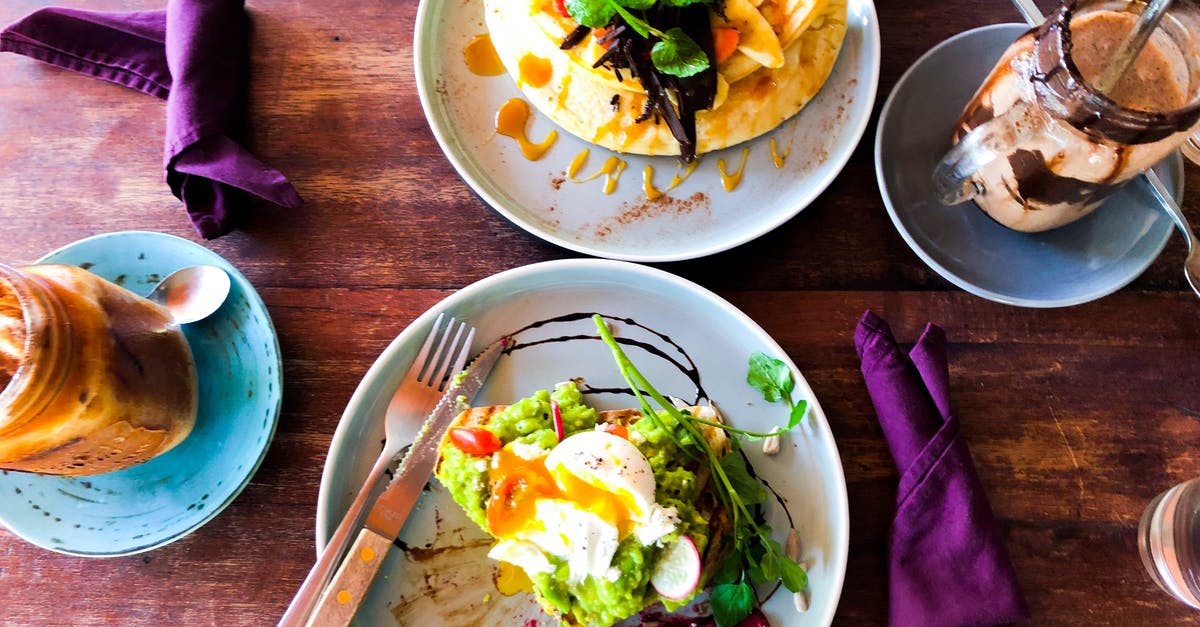 Combining melted chocolate with eggs - Vegetable Dish in White Plate on Brown Table