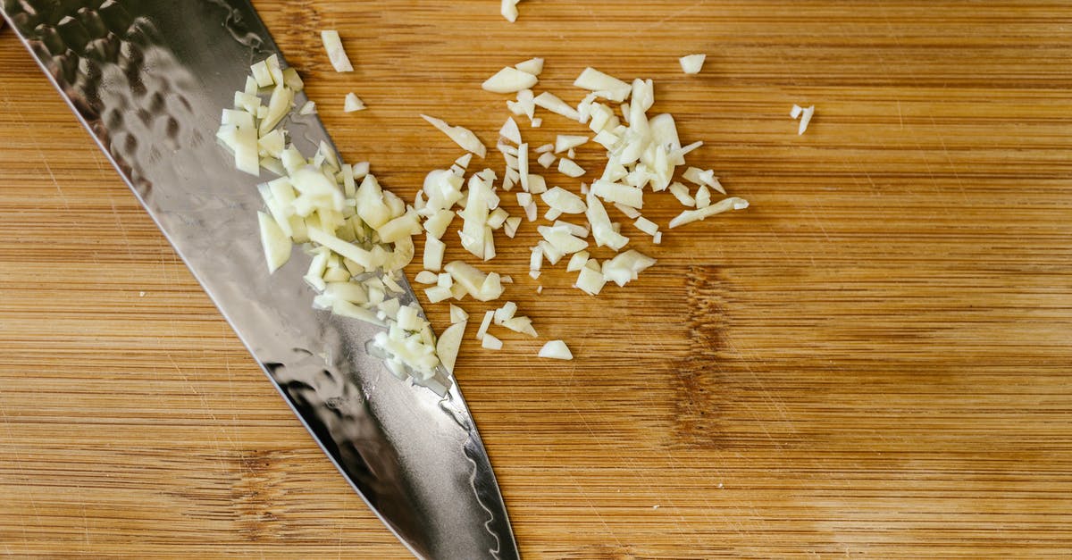 Comparing store-bought chopped garlic - Knife with Chopped Garlic on Cutting Board