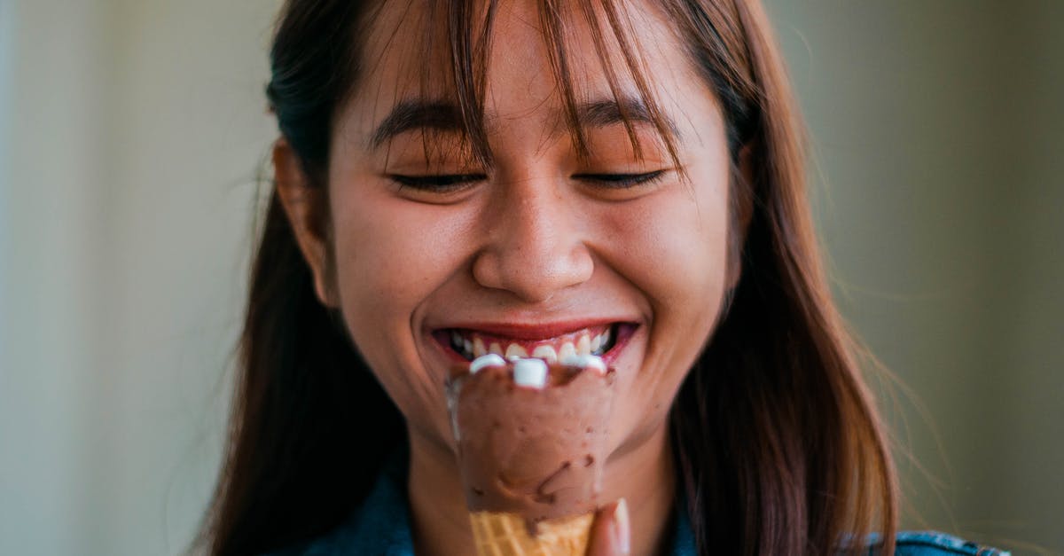 Complementary taste to elderberry ice cream? [closed] - Cheerful Asian woman with ice cream