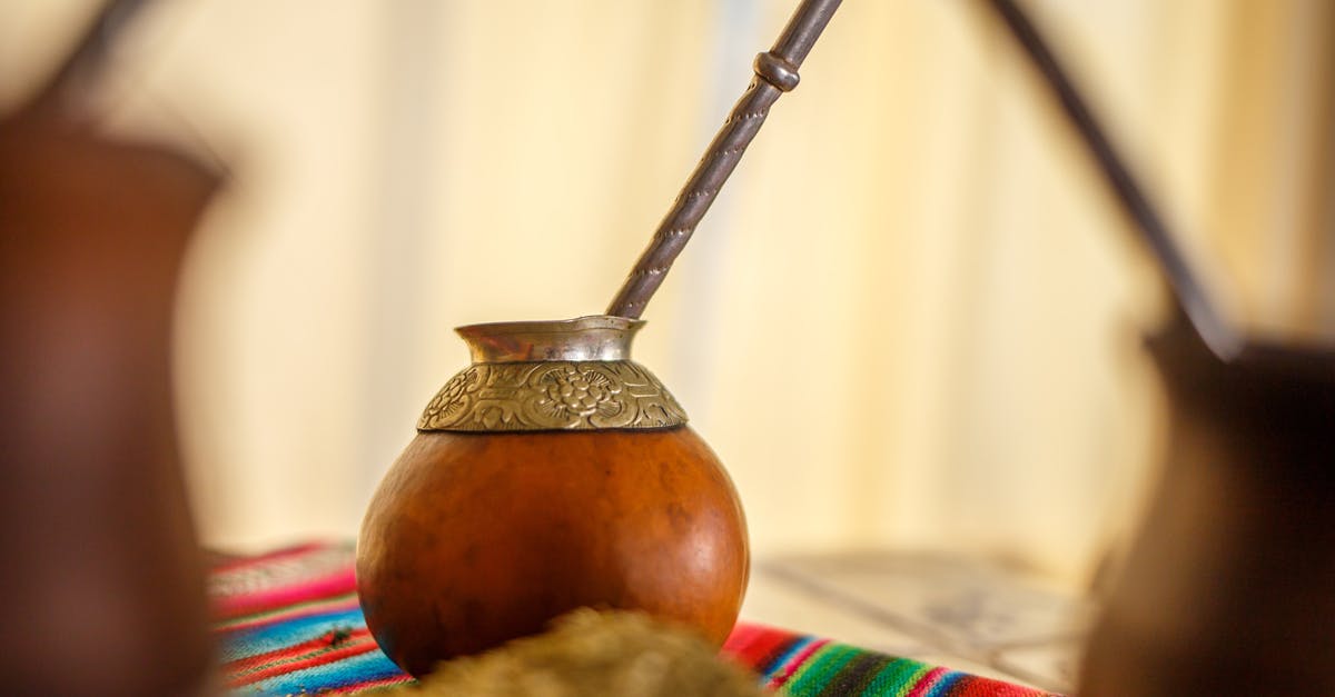 Concentrated Yerba Mate - Brown and Silver Vase on White and Blue Textile