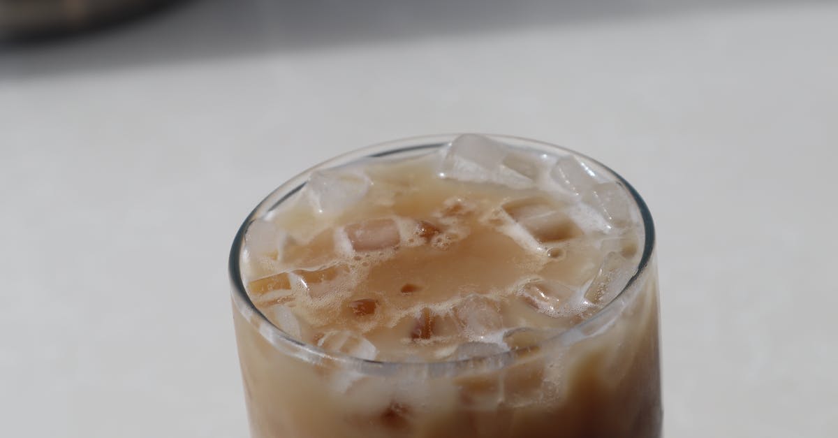 Condensed milk doesn't mix well into iced coffee - Glass of fresh iced coffee placed on table