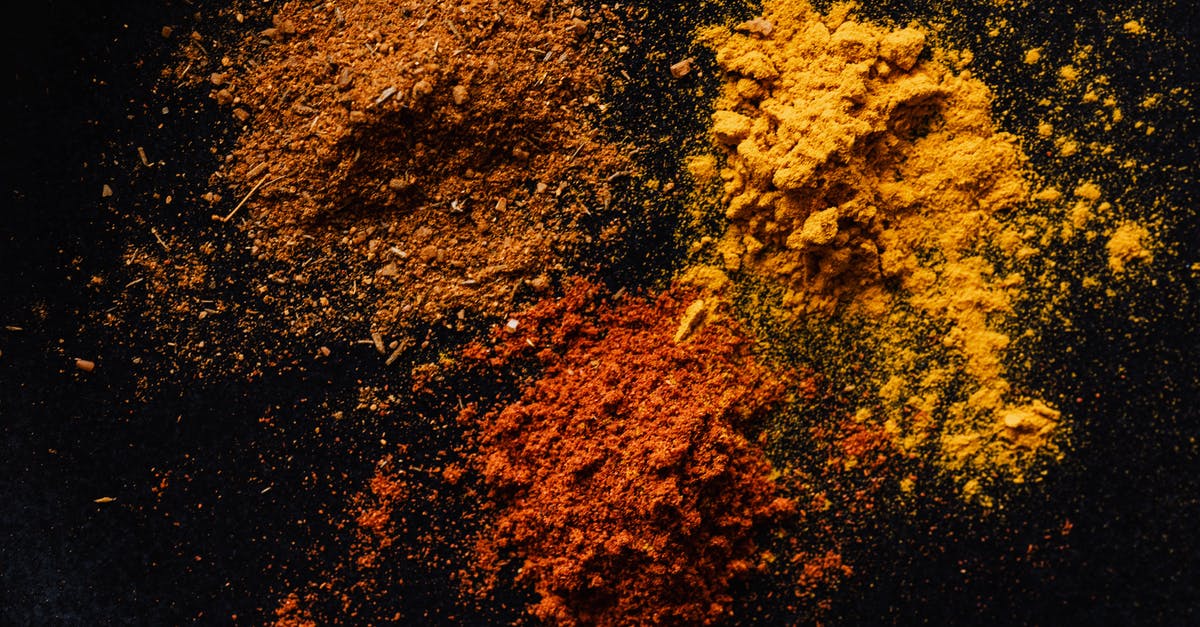 Confused about cayenne pepper, chili powder and paprika - Assorted colorful dry powdered spices on black background