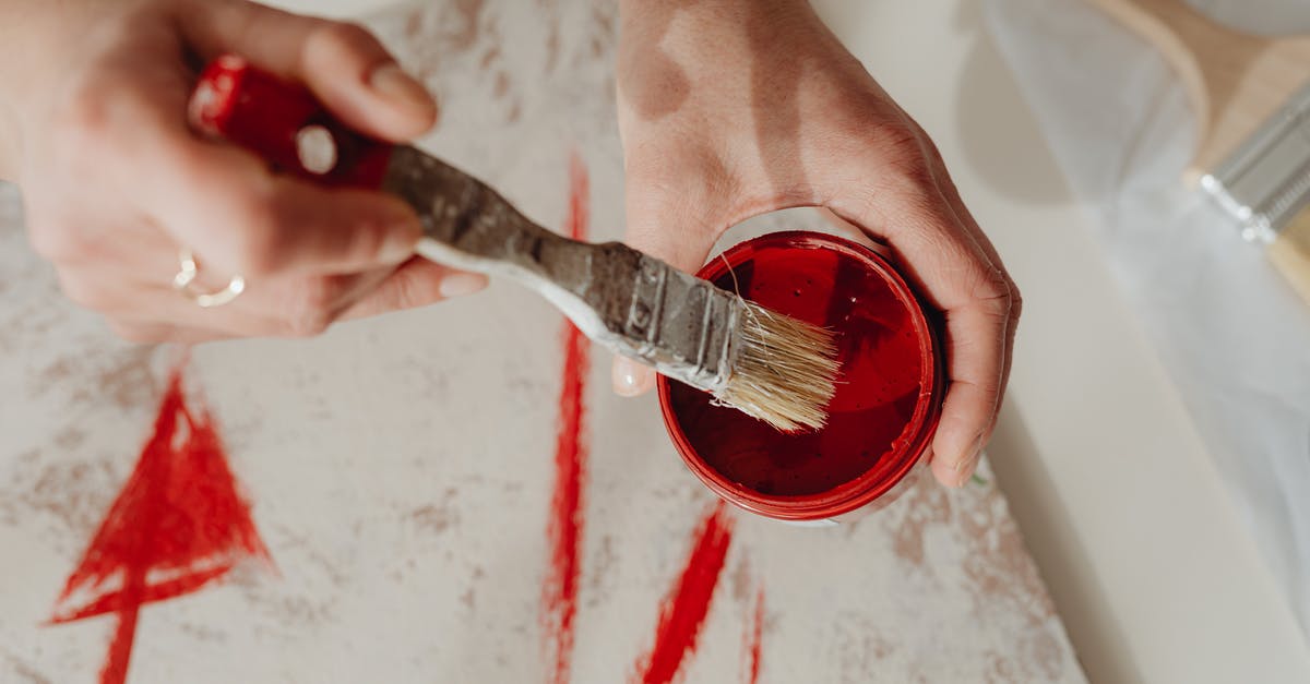 Consistently getting cannoli shells off their molds easily - Photo of a Person Getting Paint in a Container